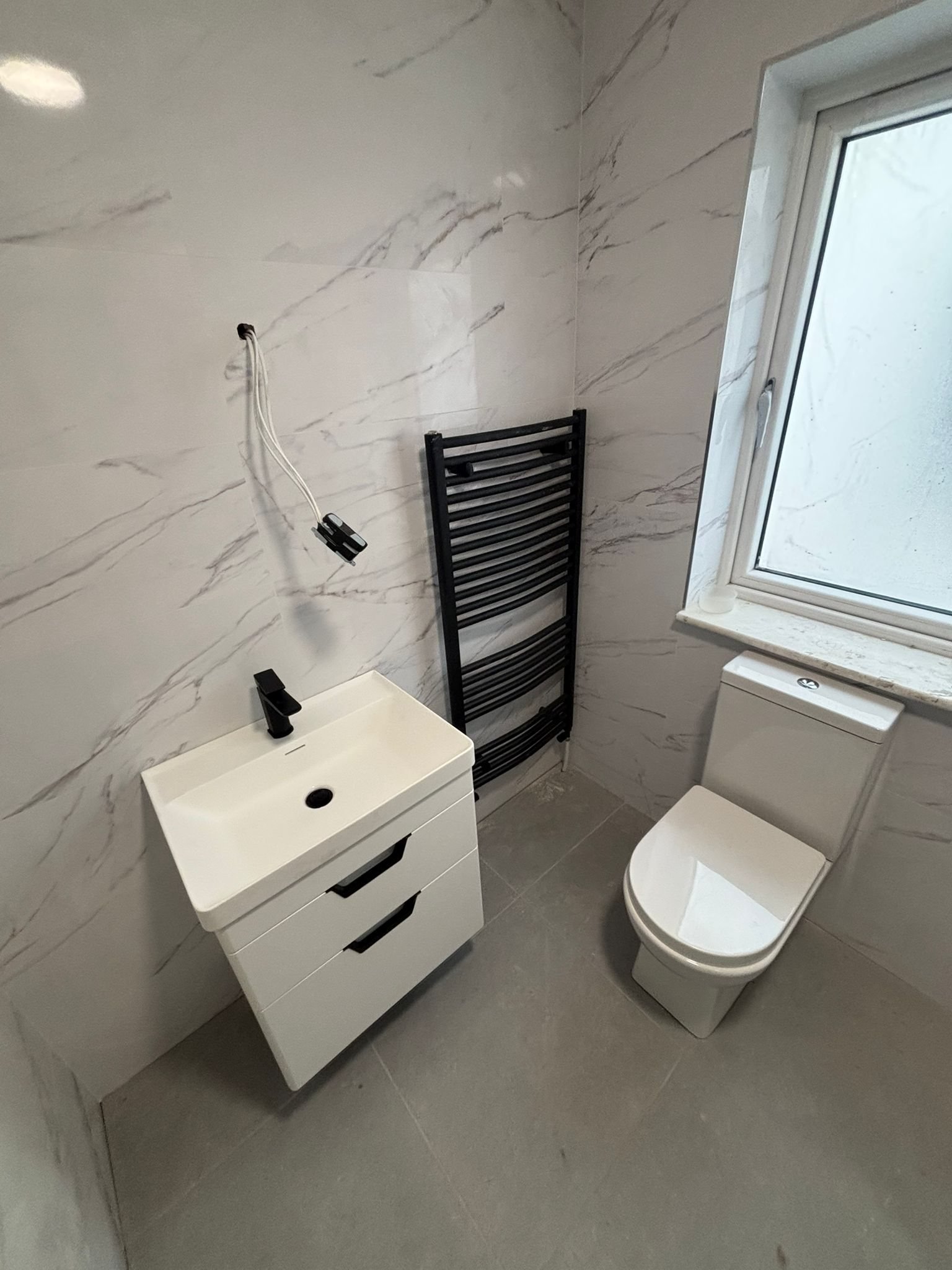 Marble bathroom with black shower in Blackrock Cork