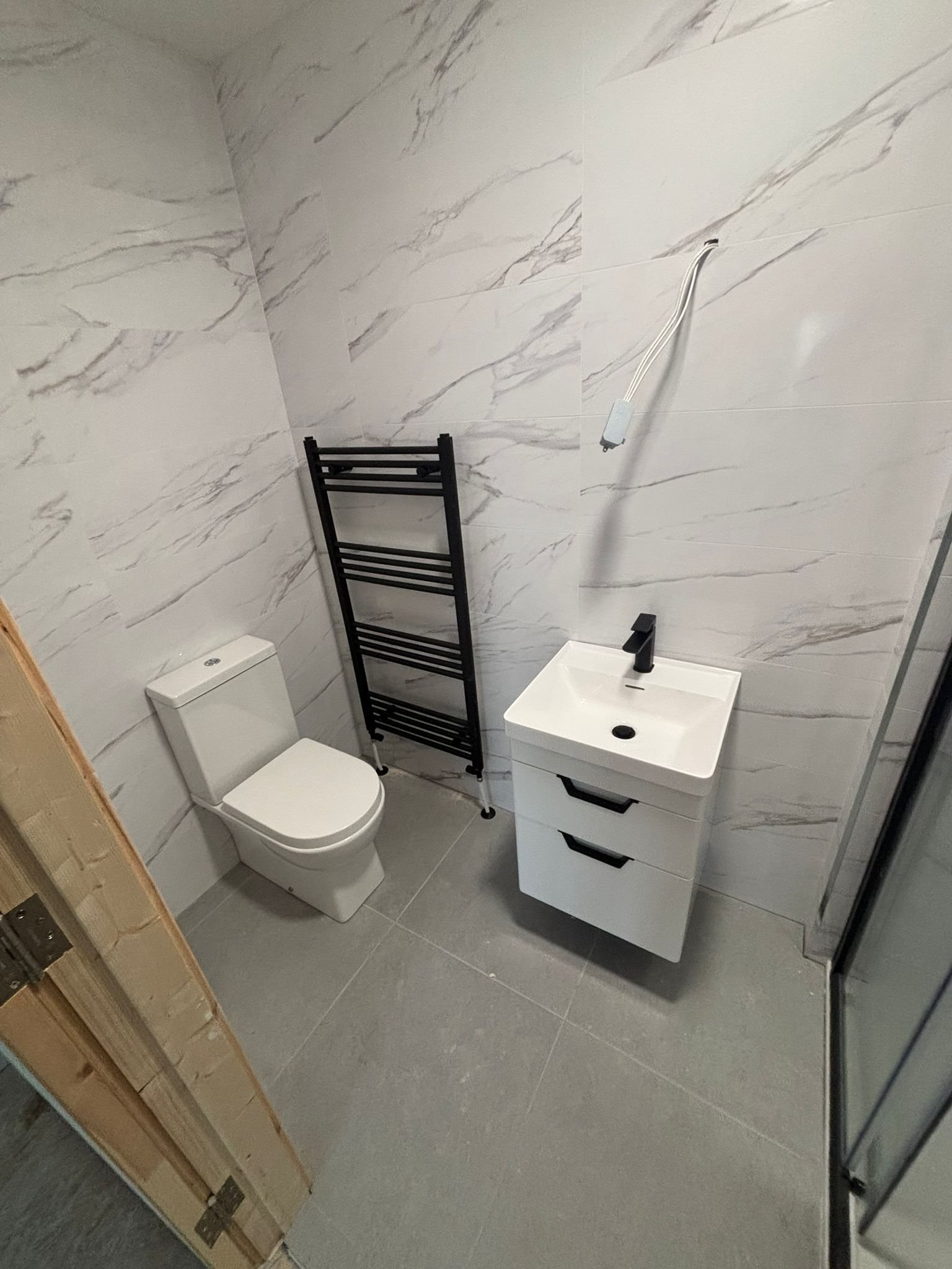 Bathroom renovation in Douglas Cork — marble tiling and black fittings